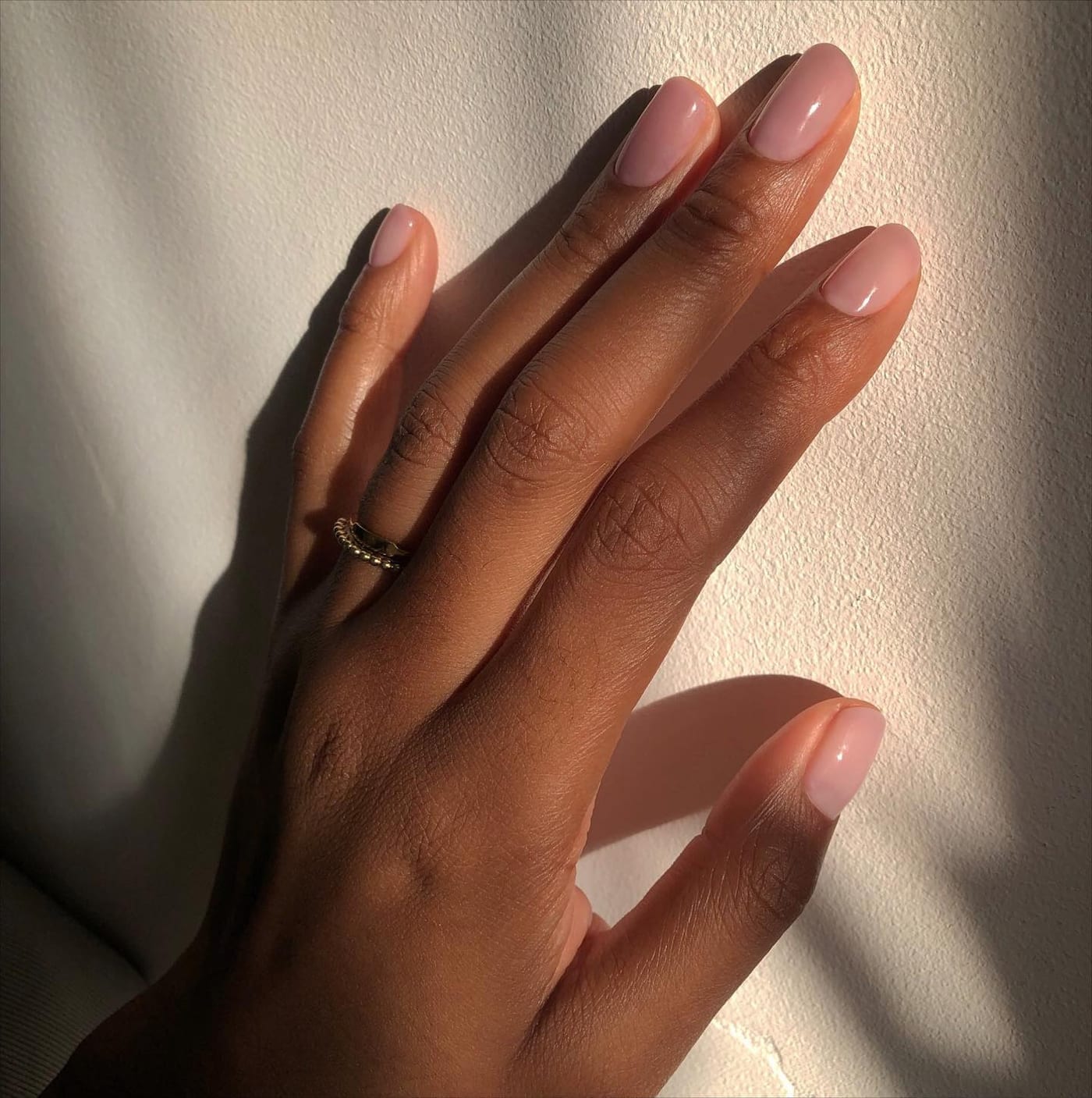 Manicurist carefully tending a client's nails