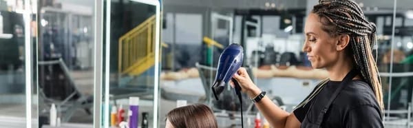 Freshly washed hair being blow-dried by a salon professional Freshly washed hair being blow-dried by a salon professional