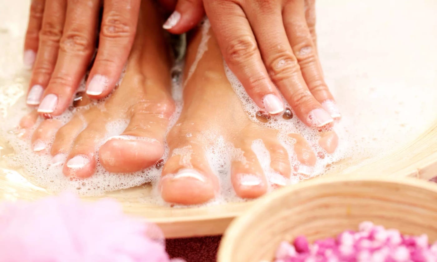 Manicure and pedicure being performed in one combined session