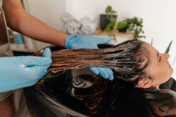 Professional restorative hair treatment applied in a salon Professional restorative hair treatment applied in a salon