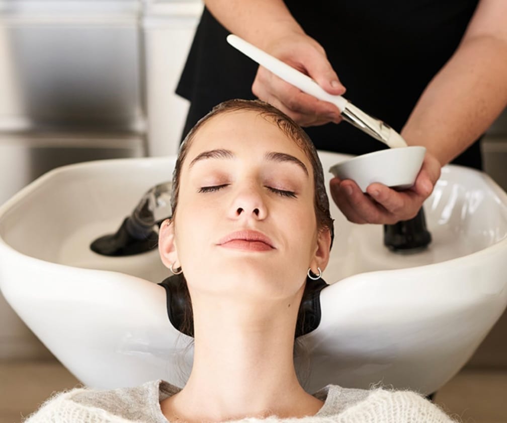 Professional applying a scalp and hair treatment in a salon Professional applying a scalp and hair treatment in a salon